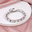 MBSS217 STAINLESS STEEL TENNIS BRACELET WITH EMERALD CUT FOILED STONE